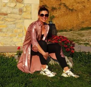 a woman sitting on a rock in the grass at Casa Rural Costalisa in Abionzo