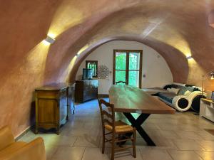 a living room with a table and a couch at Camping White Rock in Castellane