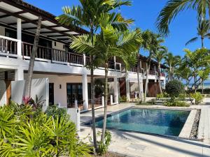 a resort with a swimming pool and palm trees at the ocean resort samui in Lamai