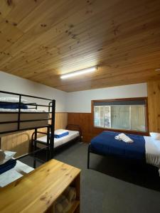 a room with two bunk beds and a wooden ceiling at Anglers Reach Lakeside Village in Anglers Reach +53 photos
