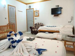 Letto o letti in una camera di Olhumathi View Inn