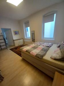 a bedroom with a bed and two windows at Ferienhaus Sankt Goar E in Sankt Goar +9 photos