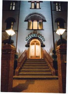 a building with a door and stairs in front of it at Hotel 2000 in Fabriano