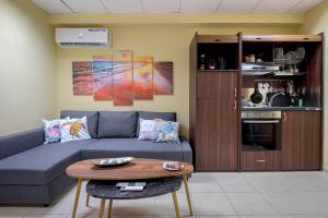 a living room with a couch and a table at City Vibes Studio in Alexandroupoli +32 photos