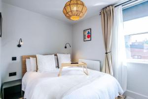 a bedroom with a bed with a table on it at Luxury 2B City Centre Apartment with Private Parking in Chester