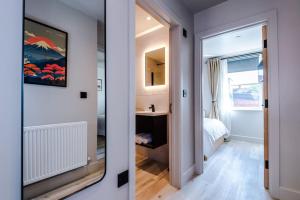 a room with a bedroom with a bed and a mirror at Luxury 2B City Centre Apartment with Private Parking in Chester +36 photos