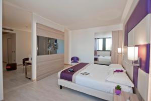 A bed or beds in a room at AS Hotel Limbiate Fiera
