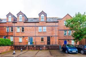 a large brick building with cars parked in front of it at Luxury 2B City Centre Apartment with Private Parking in Chester