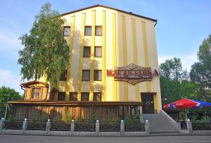 a yellow building with a sign for a hotel at Casablanca Hotel in Kalush