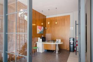 Una cocina con encimera y mesa en una habitación. en Mono Coliving Ngagel, Surabaya, en Menurpumpungan 46 fotos más