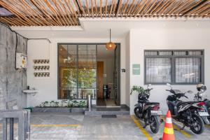 dos motocicletas estacionadas frente a un edificio en Mono Coliving Ngagel, Surabaya, en Menurpumpungan