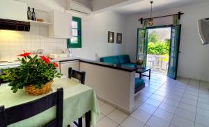 a kitchen and dining room with a table and a table and chairs at Sirius Apartments in Hersonissos