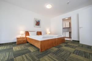 a bedroom with a bed and a table with two lamps at EG Ferienwohnung 4 Personen 1 in Rieden