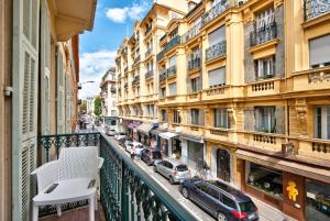 a balcony view of a street with cars and buildings at Aparthotel 9 ALBERTI Nice Centre in Nice