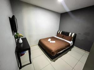 a small bedroom with a bed and a television at Ho Hotel Batu Berendam C in Malacca +10 photos