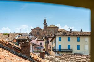 a view of a town with a church and roofs at Casa Matilla - Verde in La Morra