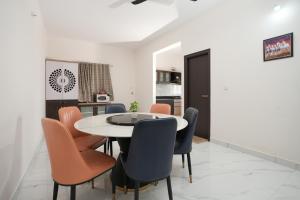 a dining room with a table and chairs at Premium Two Bedroom Apartment in Bengaluru