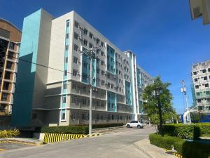 a large building with a car parked in front of it at Sunshine davao centro spatial in Davao City
