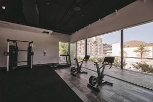 a gym with two treadmills and two exercise bikes at Hotel Astoria Playa Adults Only 4* Sup in Port d'Alcudia