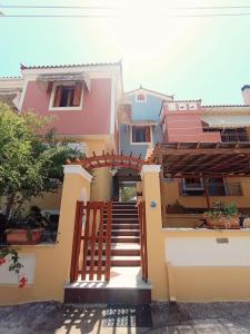 a house with a staircase in front of it at Myrstia Apartments in Pyrgi Thermis