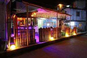 a building with a gate at night with lights at Woza Inn Boracay in Boracay