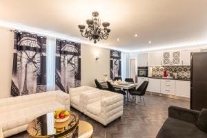 a living room with a couch and a table at Апартаменти Стефани in Plovdiv