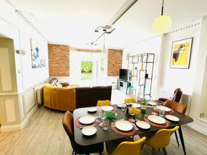 a living room with a table with chairs and a couch at New Waverleys Retreat Stunning Loft Style Ventnor in Ventnor