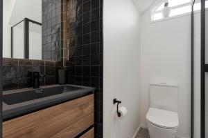 a bathroom with a sink and a toilet at Central City Entire House 2 Bedroom Free Carpark in Christchurch +6 photos