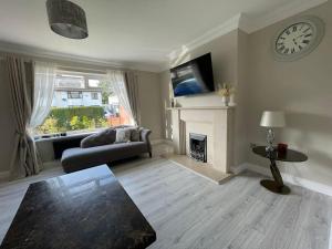 a living room with a couch and a fireplace at Luxe Residences - Preston in Preston