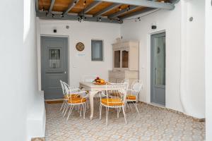 a dining room with a table and chairs at CASA DE SAL in Naxos Chora
