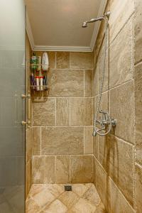 a bathroom with a shower with a glass door at Апартаменти Стефани in Plovdiv +90 photos