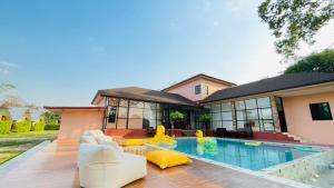 a house with a swimming pool with a house at 7Zee View เซเว่น ซี วิว in Nakhon Nayok