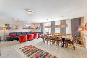 a living room with a couch and a table and chairs at Ferienhaus 6 Schlafzimmer mit Sauna UnserUsedom Ostseebad Koserow Insel Usedom in Ostseebad Koserow