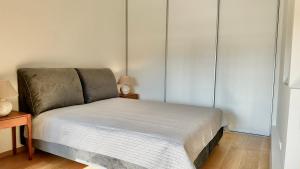 a bedroom with a bed and two lamps and a table at City Center Appartment in Vilnius