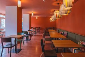 a dining room with wooden tables and chairs at Davos Youth Hostel in Davos