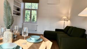 a living room with a couch and a table with wine glasses at City Center Appartment in Vilnius