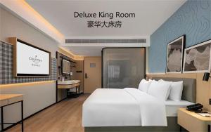 Postel nebo postele na pokoji v ubytování Country Inn & Suite by Radisson, Guangzhou Railway Station Xiaobei