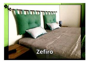 a bedroom with a bed with green pillows at Casa Vacanze VALEDORA in Ponza +15 photos