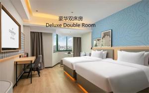 Postel nebo postele na pokoji v ubytování Country Inn & Suite by Radisson, Guangzhou Railway Station Xiaobei