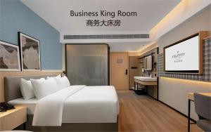 Postel nebo postele na pokoji v ubytování Country Inn & Suite by Radisson, Guangzhou Railway Station Xiaobei