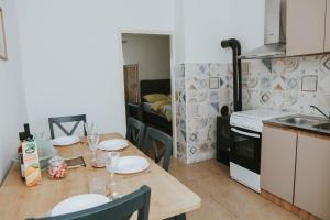 a kitchen with a table with plates on it at Studio apartman KaNa in Gospić