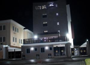 a tall building with a balcony in front of it at Luxury Hotel Deluxe Room - Sleeps 2 - Gym - Pool in Lekki