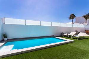 a swimming pool in the backyard of a house at Villa ConchaMar Oceanbeach in Playa Honda