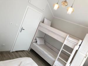 a room with a bunk bed and a ladder at Noclegi Pod Orłami in Lubaczów