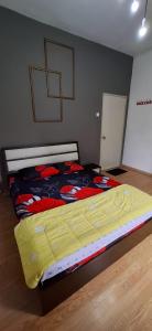 a large bed in a room with at Big Mama's House in Tanah Rata