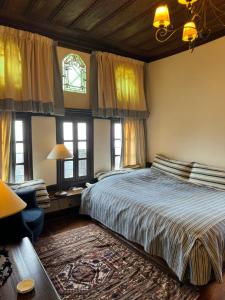 a bedroom with a large bed and a window at Santikos Mansion, Santikos Collection in Vyzitsa