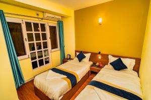 Una cama o camas en una habitación de Hotel Aashraya Home