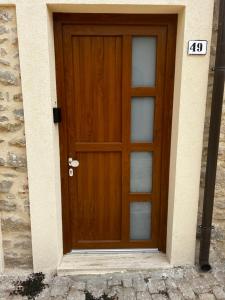 a wooden door with a sign in front of it at La Spiga in Gangi