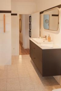 a bathroom with a sink and a mirror at Mirando al sella in Arriondas +54 photos
