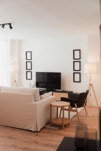 a living room with a white couch and a table at Mirando al sella in Arriondas